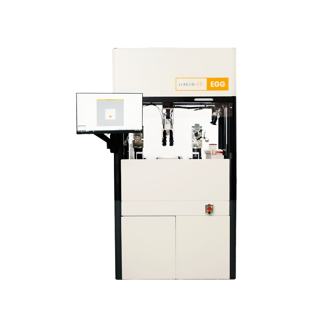 Automated laboratory machine labeled 'conceivable EGG' with a monitor on the left and robotic arms inside a white enclosure.